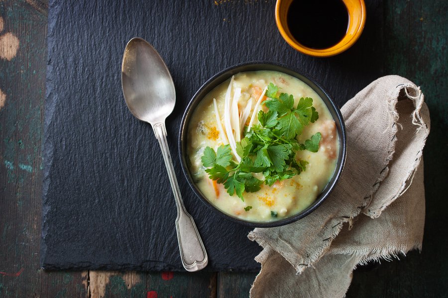 Tasty homemade curry soup with chicken and vegetables top view with copy space